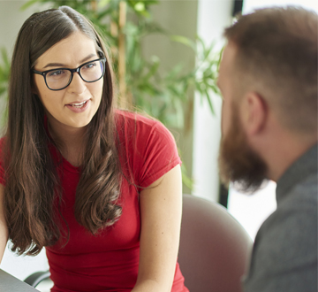 Woman in conversation with a man